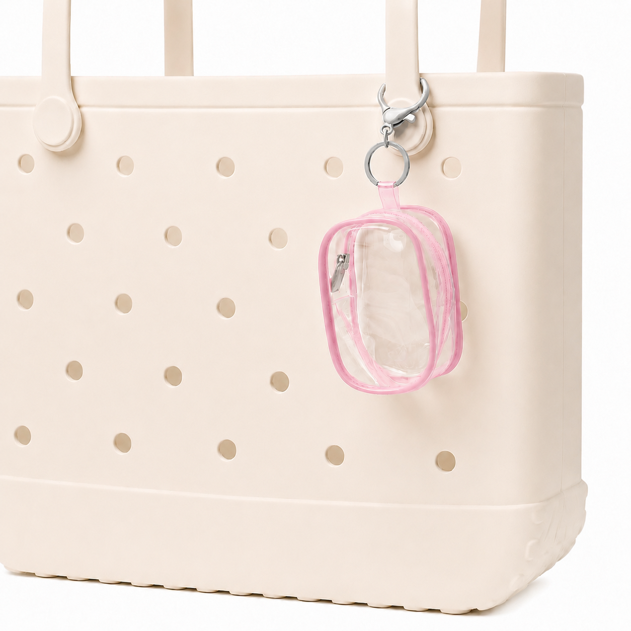Beige tote bag with gold polka dots featuring a clear pouch with pink border attached to it.