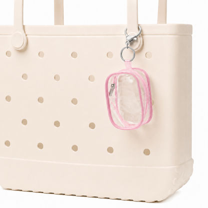 Beige tote bag with gold polka dots featuring a clear pouch with pink border attached to it.