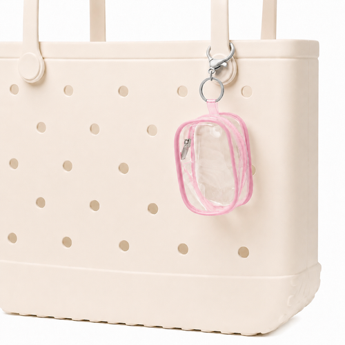 Beige tote bag with gold polka dots featuring a clear pouch with pink border attached to it.